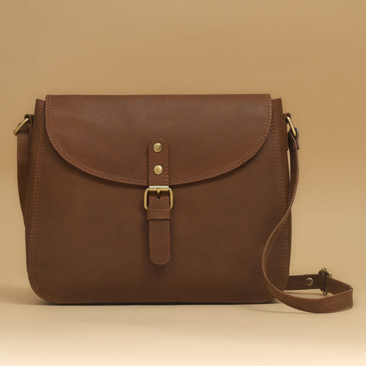 Eco-leather ginger crossbody bag with crescent silhouette and adjustable strap