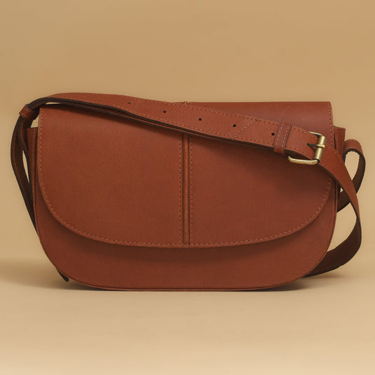 Brown eco-leather cross body bag with adjustable strap and flap closure