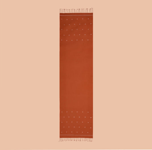 Rust-orange organic cotton stole with handwoven Jamdani motifs and fringed edges