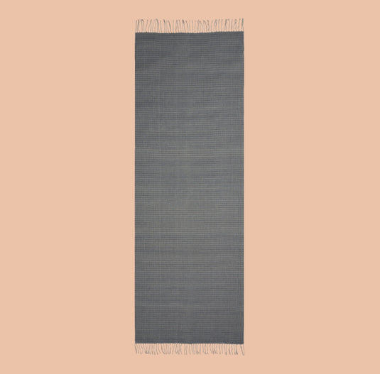 Grey organic cotton stole with subtle checks and tassels, naturally dyed and lightweight.