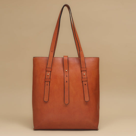Eco-leather ginger tote bag with adjustable dual shoulder straps and central strap closure in deep tan shade