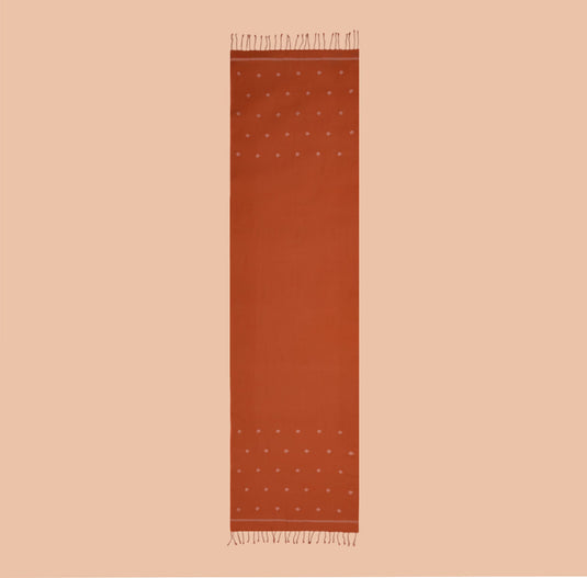 Rust orange organic cotton stole with subtle Jamdani motifs and fringed edges